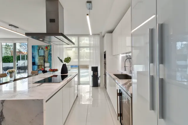 a kitchen with granite countertop a sink and a refrigerator