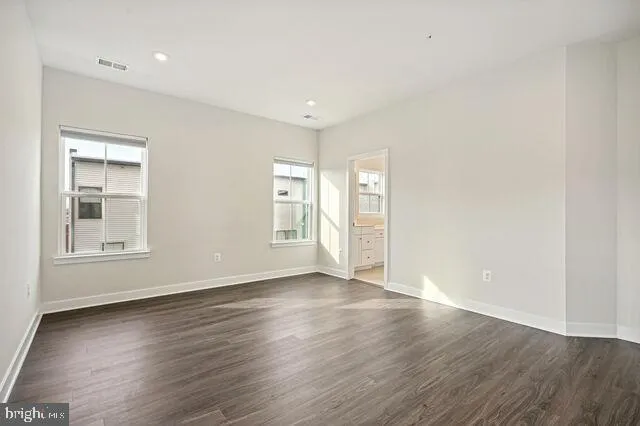 a bathroom with a double vanity sink a mirror and a bathtub