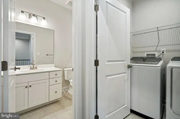 a bathroom with a sink toilet and a mirror