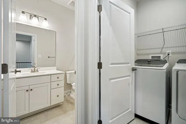a bathroom with a sink toilet and a mirror