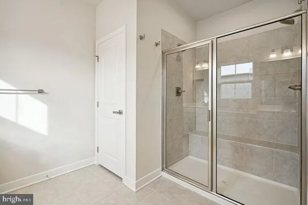 a bathroom with a sink a toilet a mirror and shower