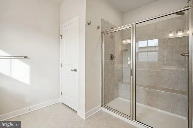 a bathroom with a sink a toilet a mirror and shower