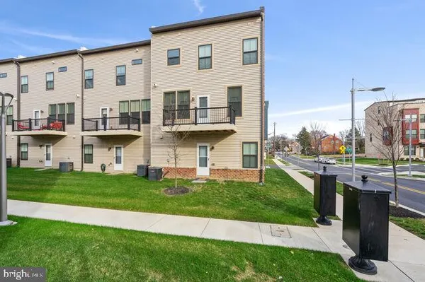 a front view of a house with a garden and plants