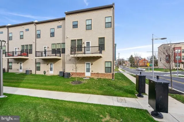 a front view of a house with a garden and plants