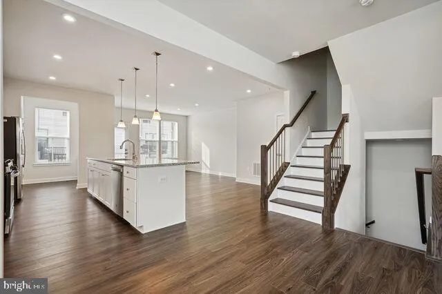 a view of a room with wooden floor