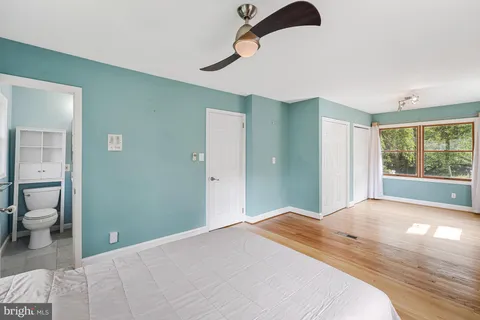 a bathroom with a toilet sink shower and mirror