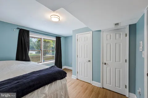 an empty room with wooden floor and chandelier