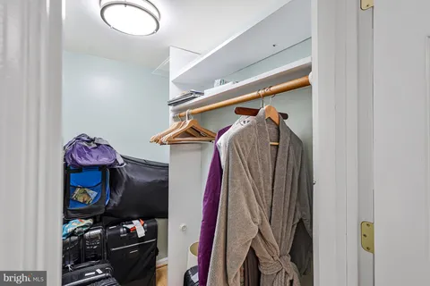 a view of a room with wooden floor and white walls
