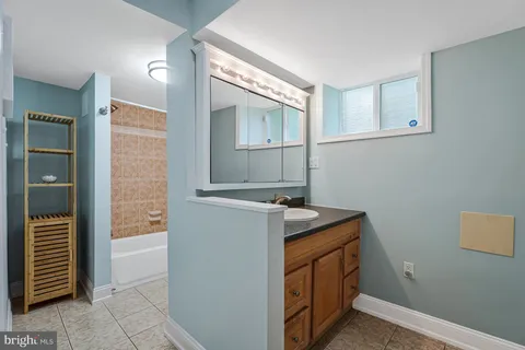 a kitchen with wooden floor and electronic appliances