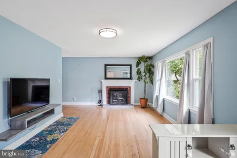 a living room with furniture fireplace and flat screen tv
