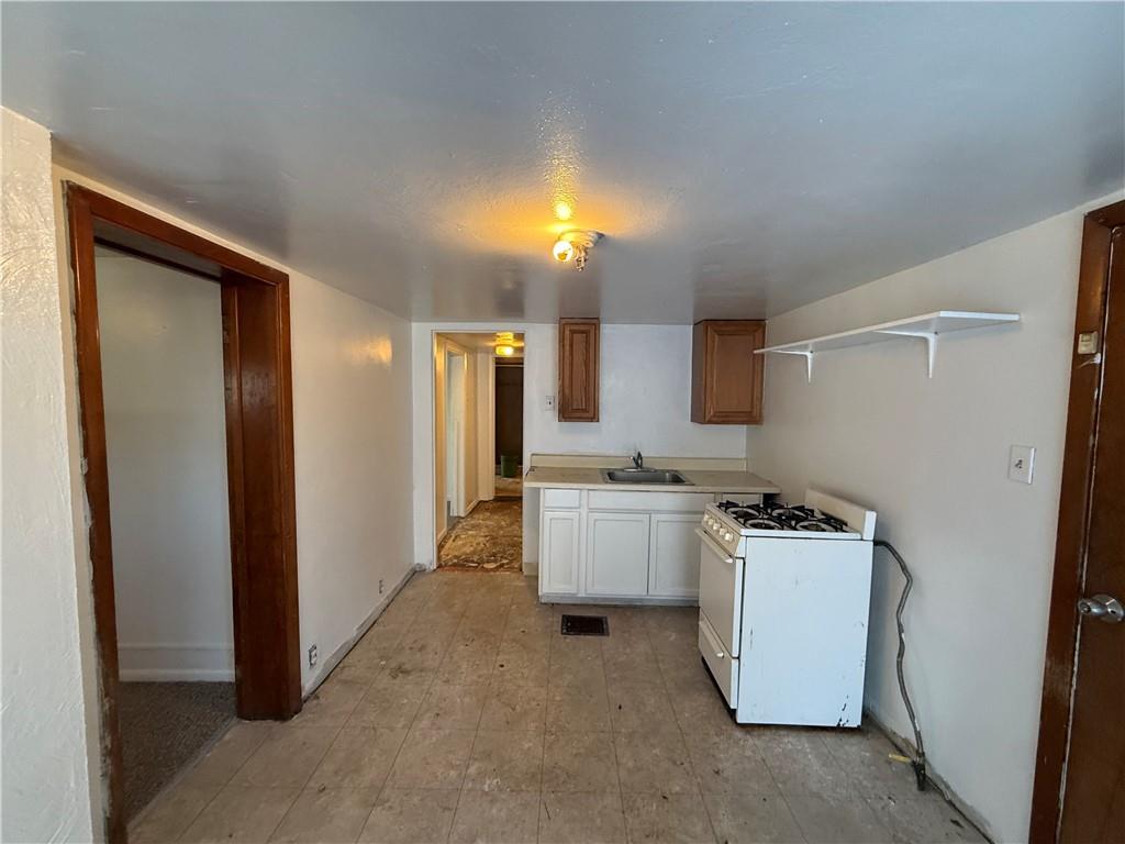 204 McCoy Road McKees Rocks, PA 15136 - Photo 23 of 25 a kitchen with cabinets and a stove