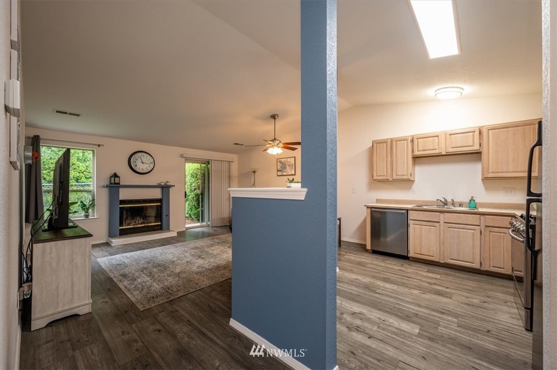 2351 Michigan Street Bellingham, WA 98229 - Photo 11 of 27 a living room with stainless steel appliances furniture a fireplace and a kitchen view