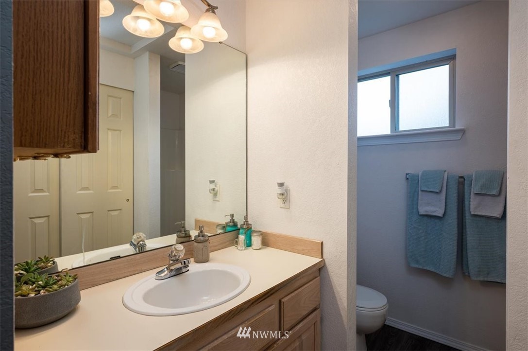 2351 Michigan Street Bellingham, WA 98229 - Photo 18 of 27 a bathroom with a sink a toilet and a mirror