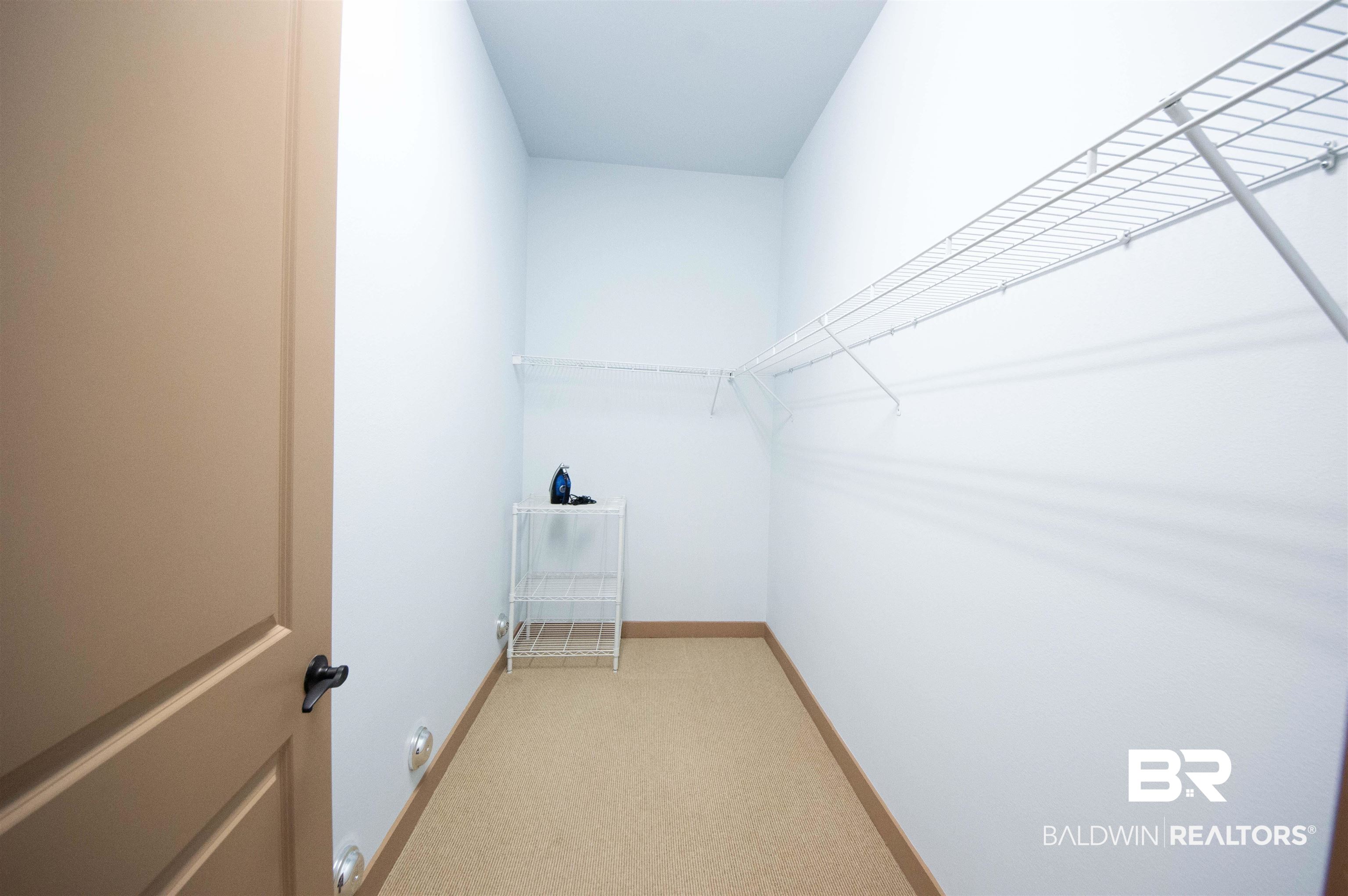 1430 Regency Road, Unit 301C Gulf Shores, AL 36542 - Photo 12 of 22 Spacious closet featuring light colored carpet
