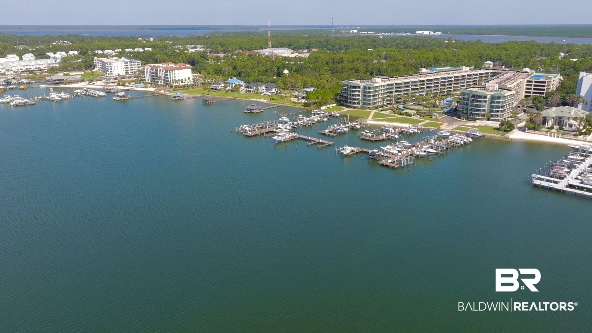 27580 Canal Road, Unit 1427 Orange Beach, AL 36561 - Photo 36 of 38 Drone / aerial view of a marina and a nearby body of water