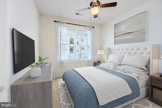 a bedroom with a large bed and flat screen tv