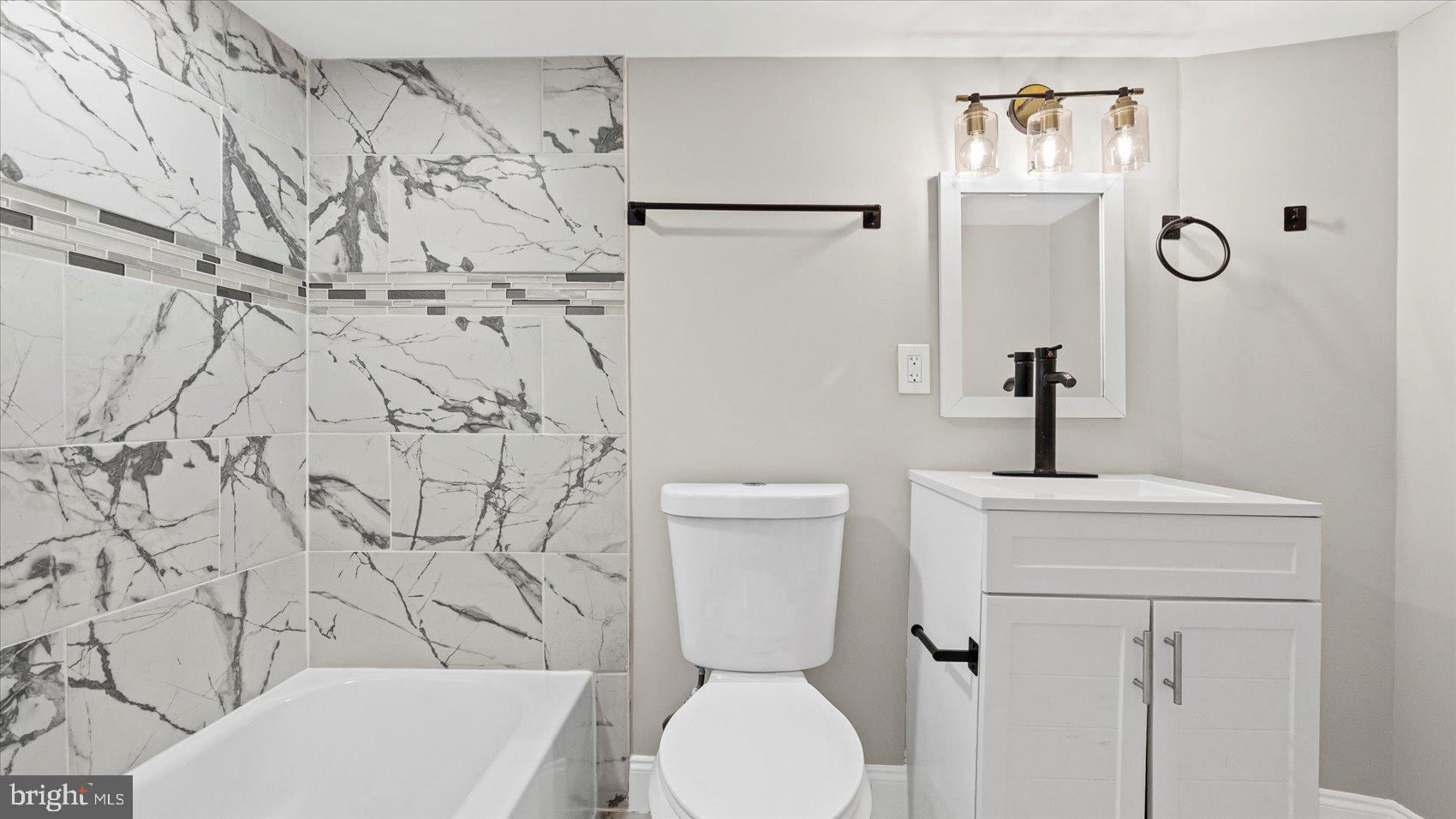 5300 Greenhill Avenue Baltimore, MD 21206 - Photo 15 of 43 a bathroom with a toilet and a sink