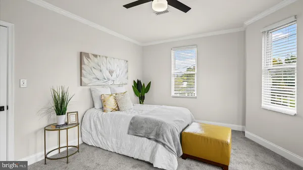 a bedroom with a bed and painting on the wall