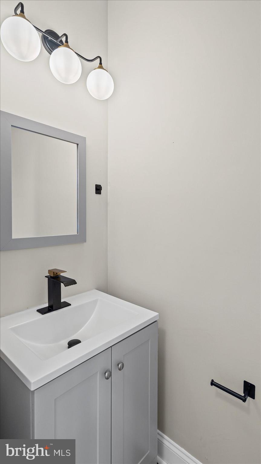 5300 Greenhill Avenue Baltimore, MD 21206 - Photo 20 of 43 a bathroom with a sink and a mirror