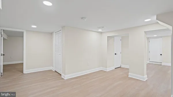 a view of an empty room with wooden floor