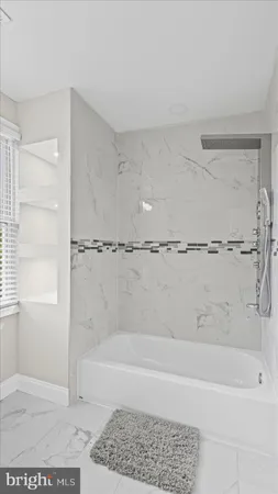 a bathroom with a bathtub and a shower