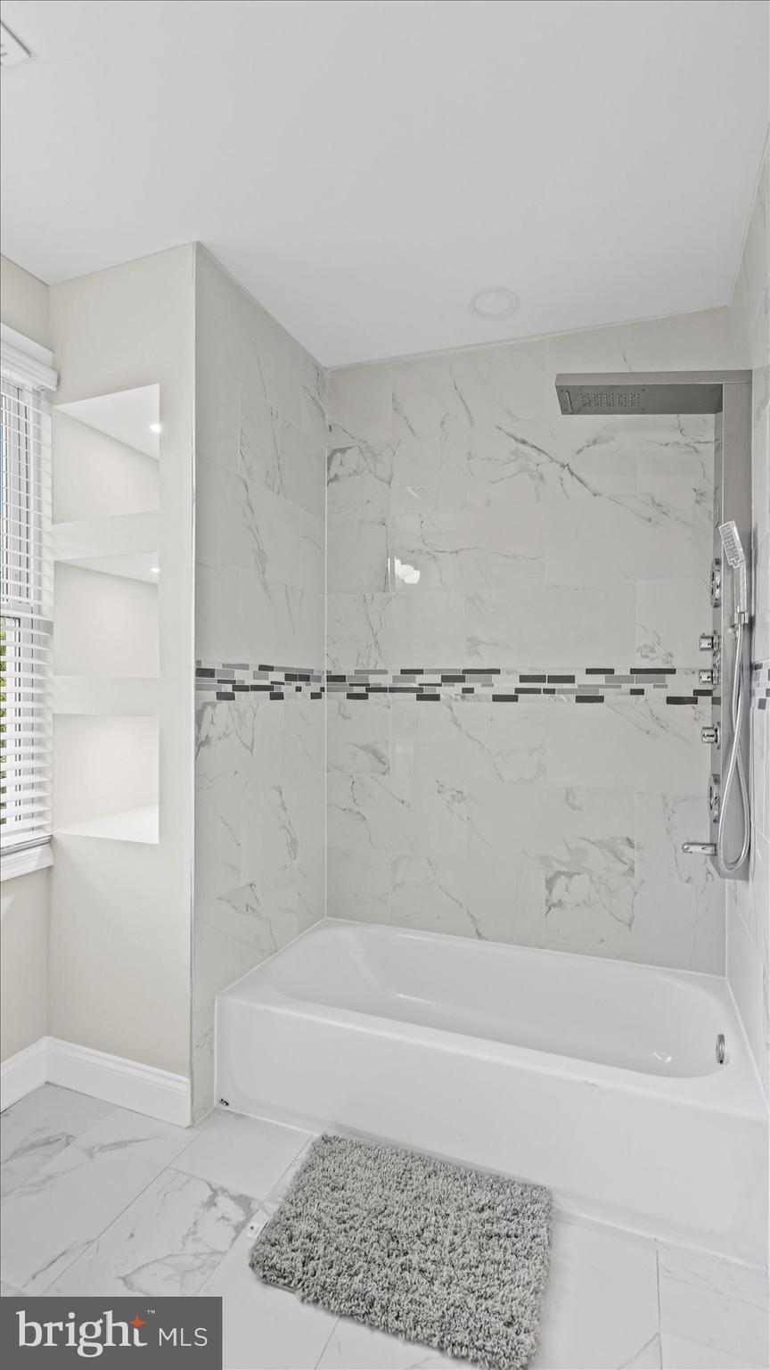 5300 Greenhill Avenue Baltimore, MD 21206 - Photo 29 of 43 a bathroom with a bathtub and a shower