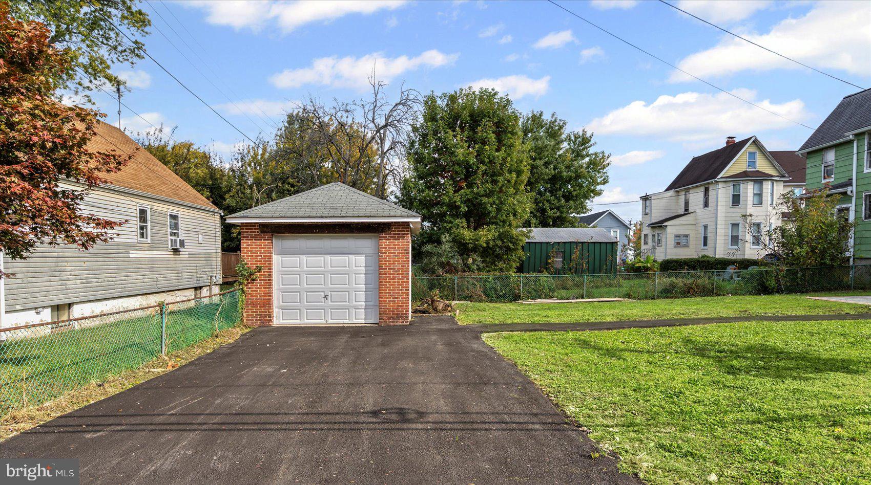 5300 Greenhill Avenue Baltimore, MD 21206 - Photo 41 of 43 a front view of a house with a yard and garage