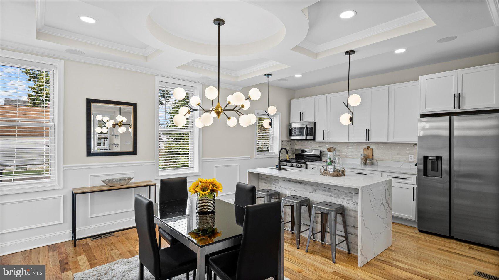 5300 Greenhill Avenue Baltimore, MD 21206 - Photo 8 of 43 a kitchen with stainless steel appliances kitchen island granite countertop a table chairs and a refrigerator