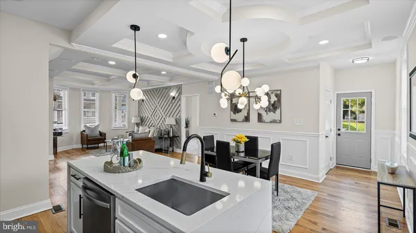 a kitchen with a sink a counter space appliances and cabinets