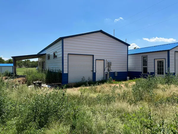 a house with green field in front of it