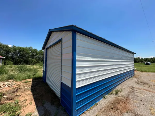 a backyard of a house with table and chairs and potted plants