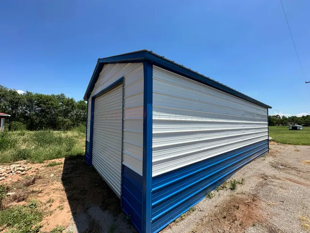 a backyard of a house with table and chairs and potted plants