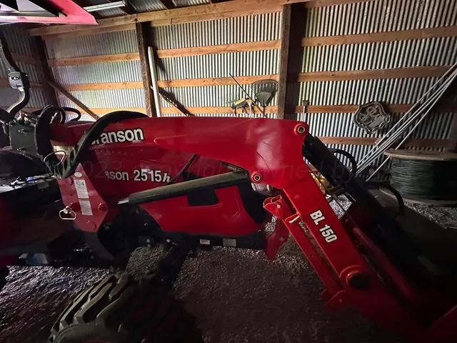 a view of a grassy field with trees in the background