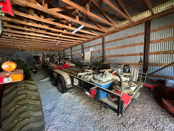 a view of a grassy field with an trees in the background