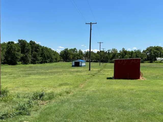 a room with lots of residential buildings and car parked