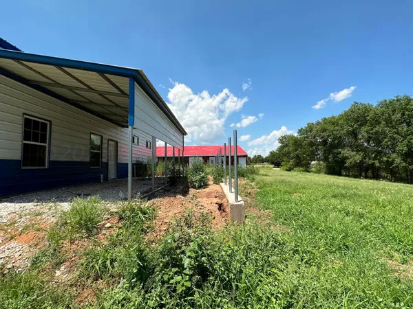 a view of a house with a backyard and a garden