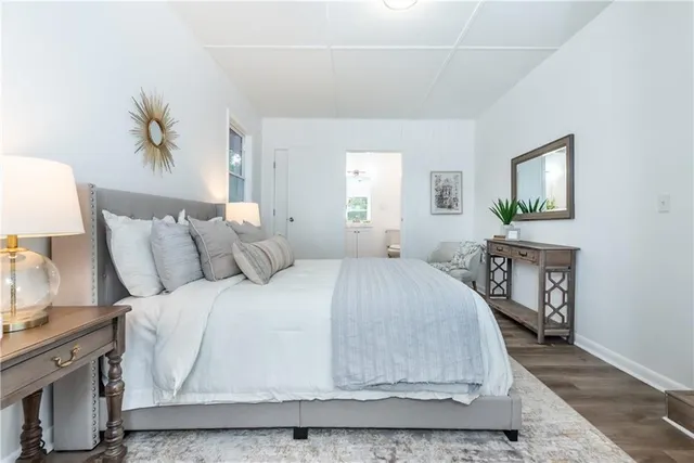 a spacious bedroom with a bed a couch and a window