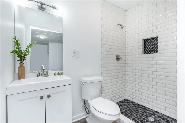 a bathroom with a toilet a sink and mirror