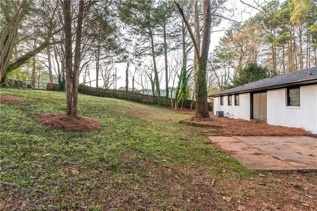 a view of a house with a tree in the forest