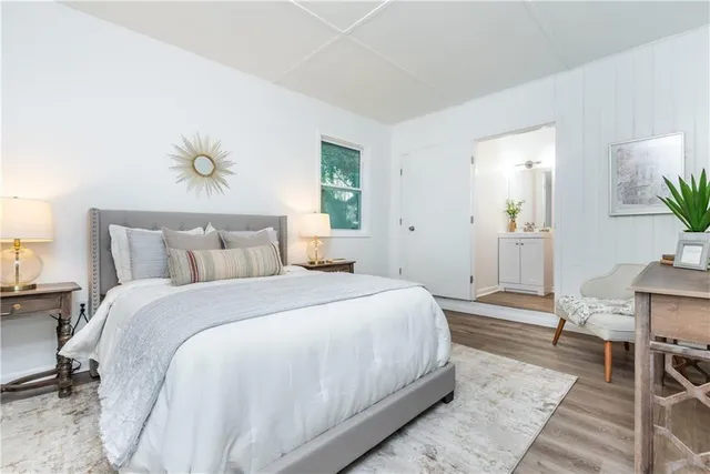 a bedroom with a bed table and chair