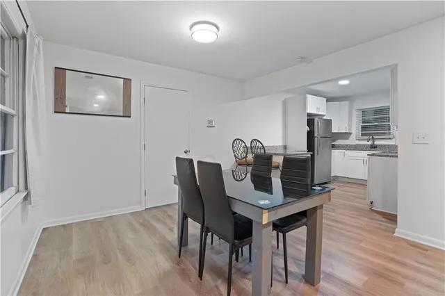 a view of a dining room with furniture and wooden floor