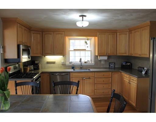 25 Mc Intosh Road Chelmsford, MA 01824 - Photo 4 of 10 a kitchen with kitchen island granite countertop a sink cabinets and window