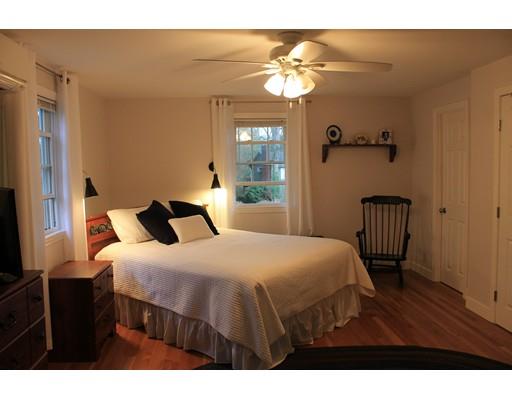 25 Mc Intosh Road Chelmsford, MA 01824 - Photo 7 of 10 a bedroom with a bed and a chandelier