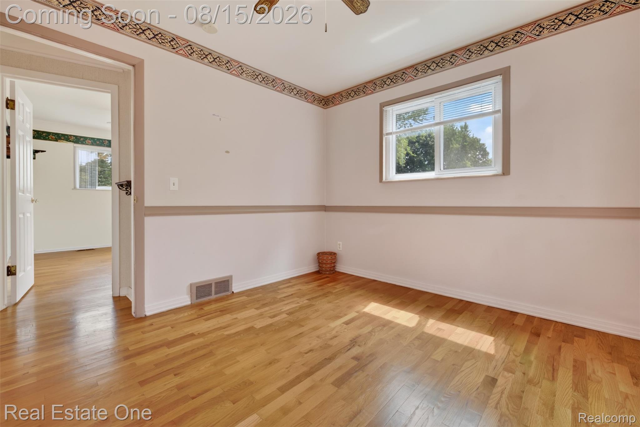 454 South Baldwin Road Oxford, MI 48371 - Photo 20 of 64 Hardwood flooring, painted walls with decorative trim, and a window with blinds