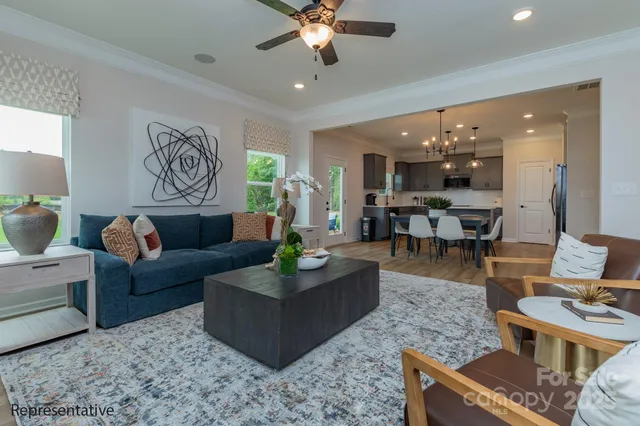 a living room with furniture and a chandelier