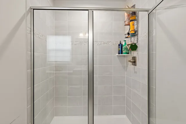 a bathroom with a glass shower door
