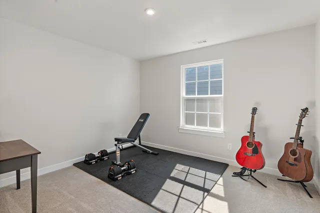 a room with gym equipment and a window
