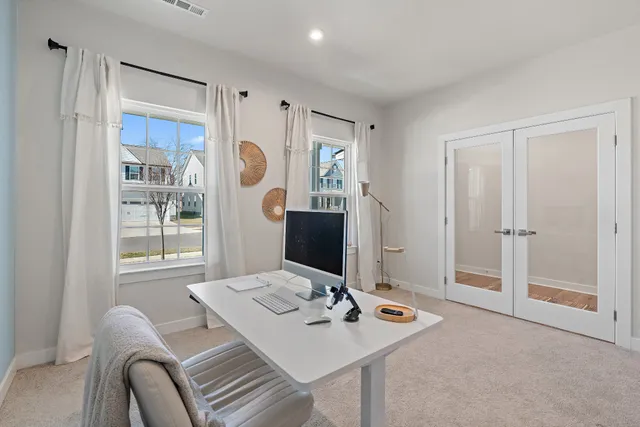 a view of a workspace with furniture and window