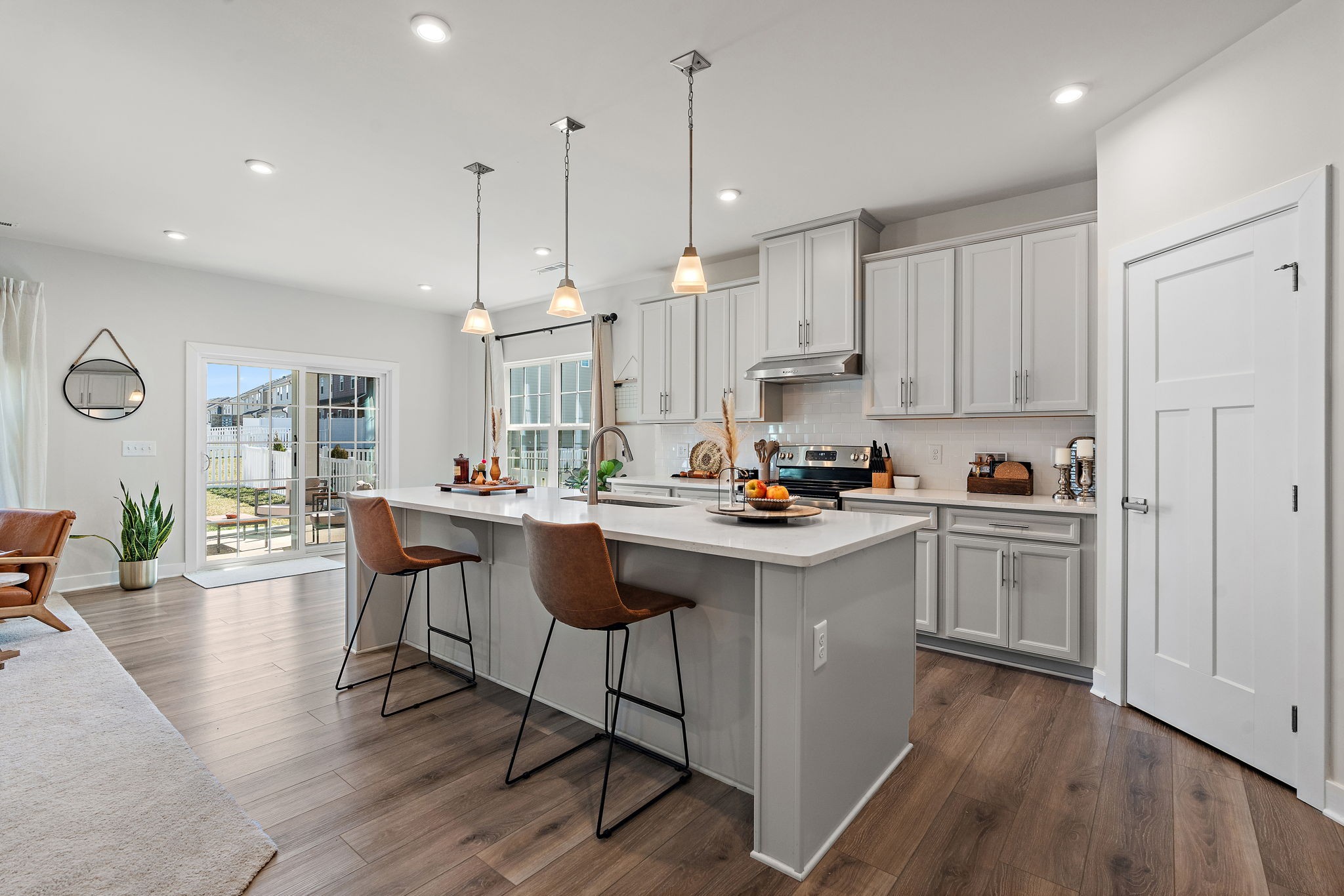 406 Ryan Avenue Gallatin, TN 37066 - Photo 10 of 45 a kitchen that has a lot of cabinets in it with stainless steel appliances granite countertop a sink a stove a refrigerator and white cabinets with wooden floor