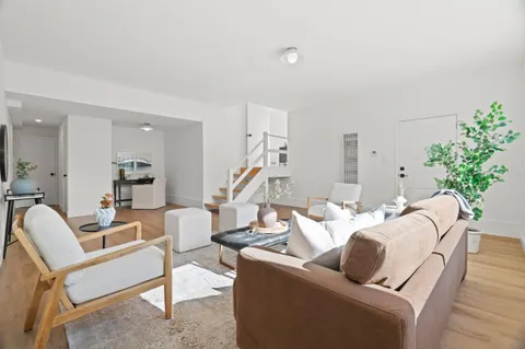 a living room with furniture and flowers